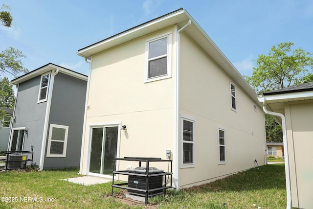 1205 Neva St, Jacksonville, FL 32205 - back of property featuring stucco siding, a yard, and central AC unit