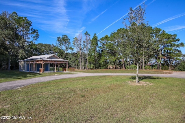 61 Sunrise Vista Way, Ponte Vedra, FL 32081 - view of grassy yard with curved driveway and view of wooded area