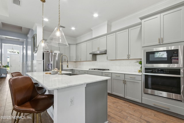 61 Sunrise Vista Way, Ponte Vedra, FL 32081 - kitchen featuring gray cabinetry, stainless steel appliances, crown molding, a sink, and wood finished floors