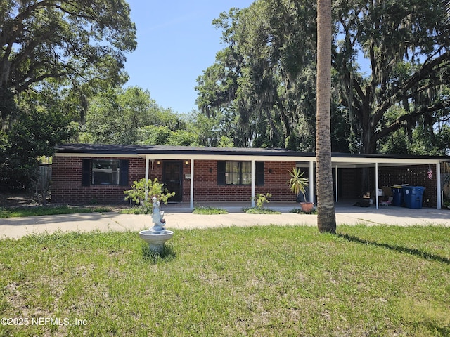 2242 Lake Lucina Dr, Jacksonville, FL 32211 - ranch-style home with a front yard, an attached carport, and brick siding