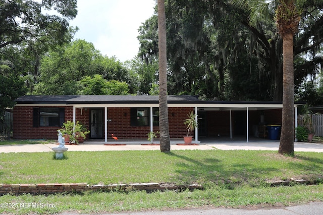 2242 Lake Lucina Dr, Jacksonville, FL 32211 - single story home with a front yard, a carport, and brick siding