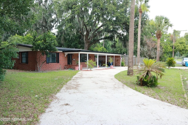 2242 Lake Lucina Dr, Jacksonville, FL 32211 - ranch-style house with asphalt driveway, brick siding, and view of scattered trees