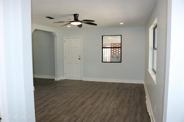 2242 Lake Lucina Dr, Jacksonville, FL 32211 - empty room featuring a ceiling fan, dark wood-style flooring, arched walkways, baseboards, and recessed lighting