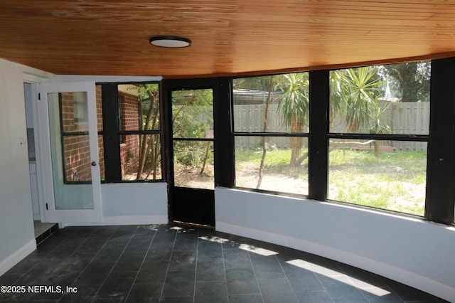 2242 Lake Lucina Dr, Jacksonville, FL 32211 - unfurnished sunroom with wood ceiling, healthy amount of natural light, baseboards, and tile patterned floors