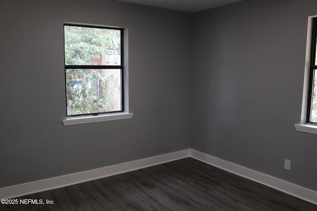 2242 Lake Lucina Dr, Jacksonville, FL 32211 - spare room featuring baseboards and dark wood-style flooring