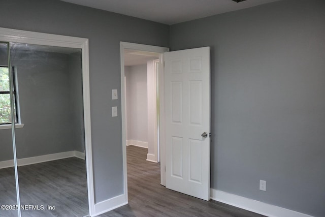 2242 Lake Lucina Dr, Jacksonville, FL 32211 - unfurnished bedroom featuring dark wood finished floors, baseboards, and a closet