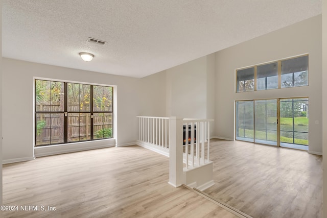 1701 Wood Hill Pl Unit 1701, Jacksonville, FL 32256 - empty room with wood finished floors, a textured ceiling, and baseboards