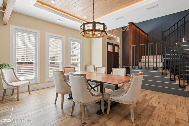 520 E Coast Dr, Atlantic Beach, FL 32233 - dining space with a tray ceiling, a chandelier, stairway, light wood-style flooring, and wood ceiling