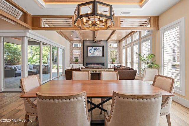 520 E Coast Dr, Atlantic Beach, FL 32233 - dining room with light wood-style floors, a fireplace, a chandelier, and recessed lighting