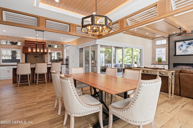 520 E Coast Dr, Atlantic Beach, FL 32233 - dining room featuring a chandelier, recessed lighting, light wood-style floors, wood ceiling, and a fireplace