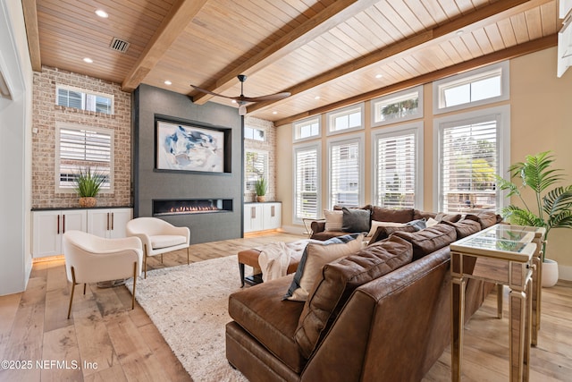 520 E Coast Dr, Atlantic Beach, FL 32233 - living room featuring wooden ceiling, light wood-type flooring, beam ceiling, a fireplace, and recessed lighting