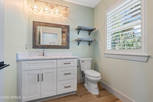 520 E Coast Dr, Atlantic Beach, FL 32233 - bathroom featuring wood finished floors, toilet, baseboards, and vanity