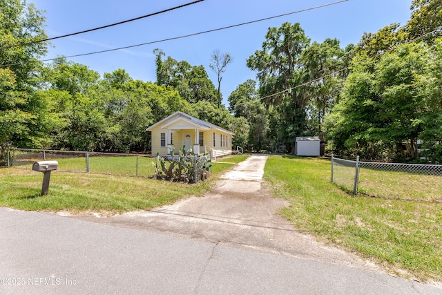 4242 Turton Ave, Jacksonville, FL 32208 - view of front facade featuring concrete driveway, an outdoor structure, and a shed