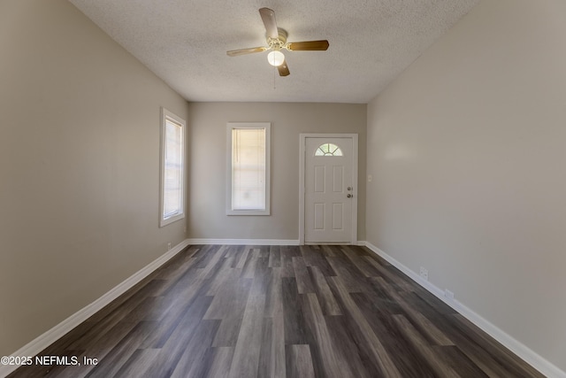 4242 Turton Ave, Jacksonville, FL 32208 - foyer featuring a textured ceiling, dark wood-style flooring, ceiling fan, and baseboards