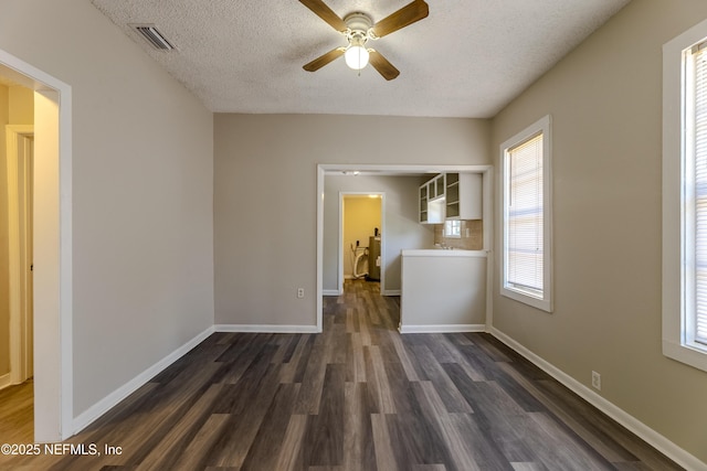 4242 Turton Ave, Jacksonville, FL 32208 - empty room featuring dark wood-style floors, a textured ceiling, ceiling fan, and baseboards