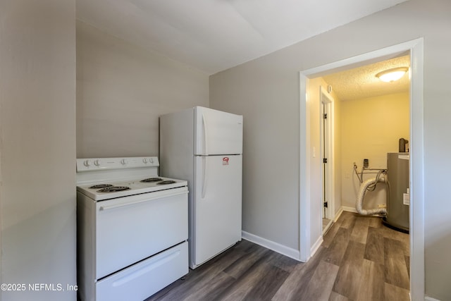 4242 Turton Ave, Jacksonville, FL 32208 - kitchen with white appliances, dark wood-type flooring, water heater, and baseboards
