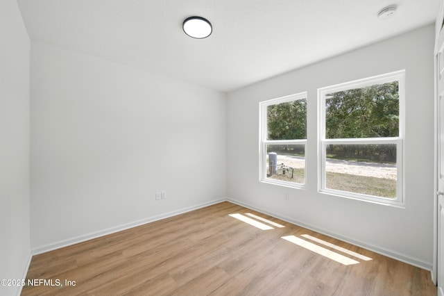 323 Rustic Rd, Satsuma, FL 32189 - empty room with light wood-style floors, a smoke detector, and baseboards