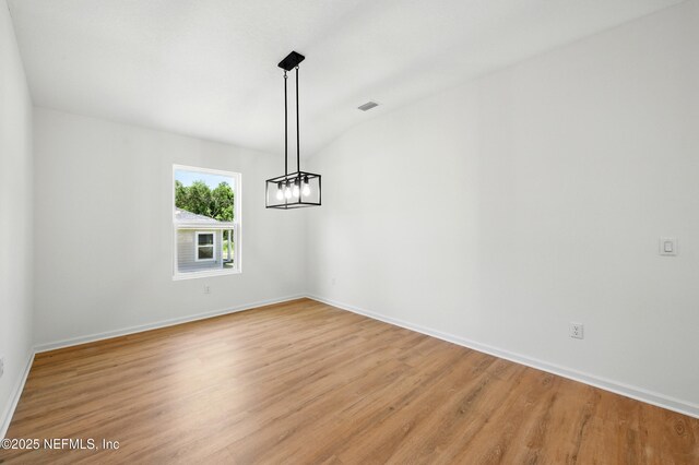 323 Rustic Rd, Satsuma, FL 32189 - unfurnished room with light wood-type flooring, baseboards, and a chandelier