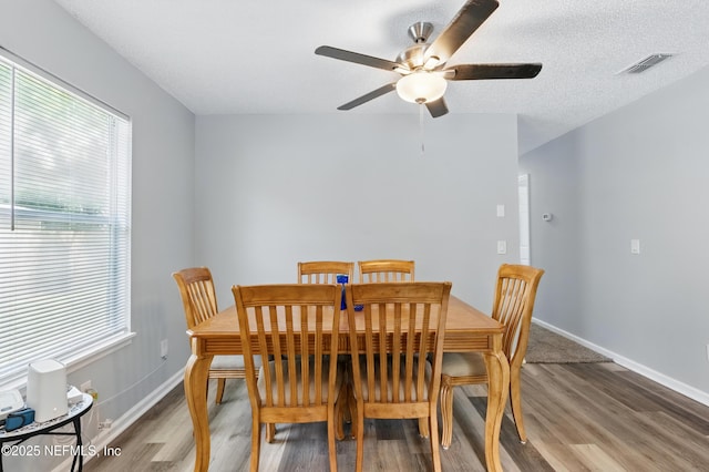1961 Spring Drive Rd, Jacksonville, FL 32209 - dining area featuring wood finished floors, healthy amount of natural light, a ceiling fan, and baseboards