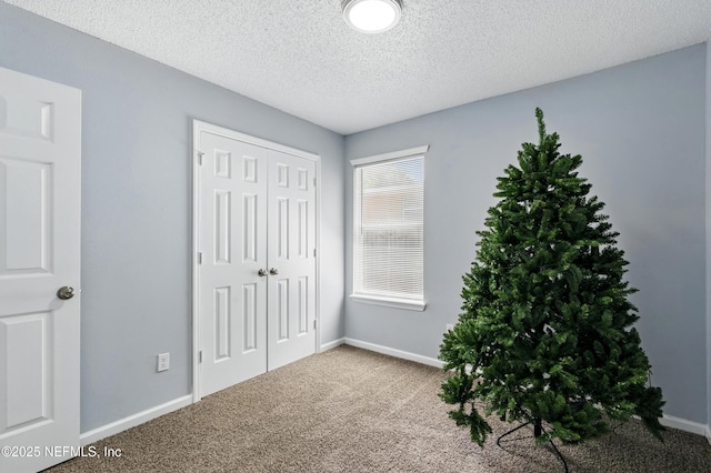 1961 Spring Drive Rd, Jacksonville, FL 32209 - unfurnished bedroom with carpet floors, a closet, baseboards, and a textured ceiling