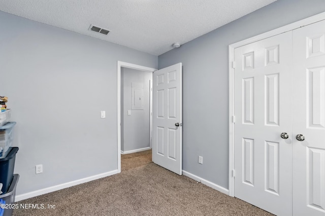 1961 Spring Drive Rd, Jacksonville, FL 32209 - unfurnished bedroom featuring carpet floors, baseboards, and a textured ceiling