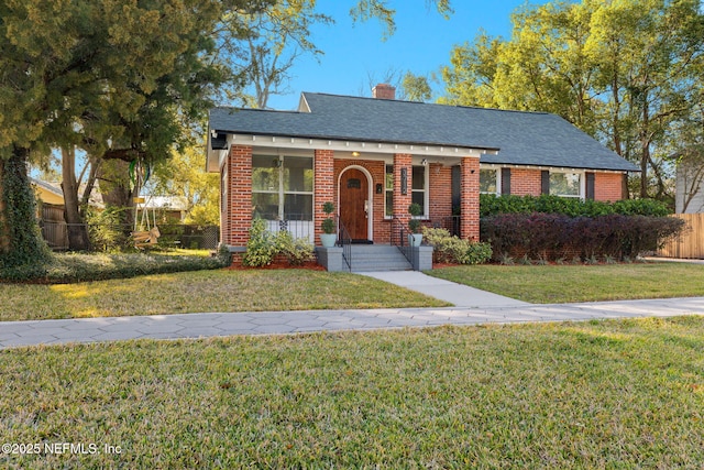 3712 Trask St, Jacksonville, FL 32205 - view of front of property with brick siding, a porch, a chimney, and roof with shingles