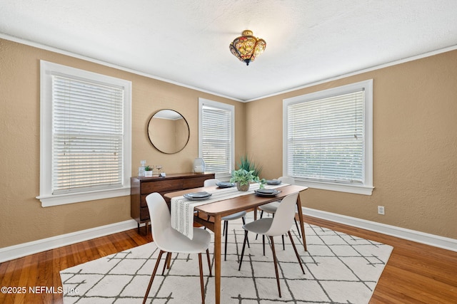3712 Trask St, Jacksonville, FL 32205 - dining area with wood finished floors, crown molding, baseboards, and a textured wall
