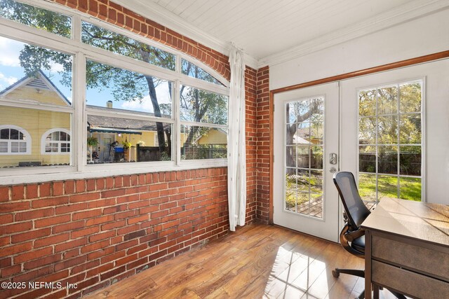 3712 Trask St, Jacksonville, FL 32205 - sunroom with french doors, brick wall, hardwood / wood-style flooring, ornamental molding, and healthy amount of natural light