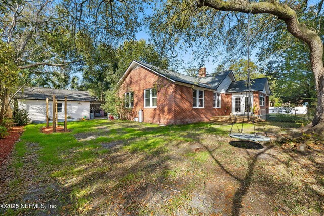 3712 Trask St, Jacksonville, FL 32205 - view of side of home featuring brick siding and a chimney