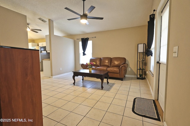 502 Vermont Ave, Green Cove Springs, FL 32043 - living area featuring a ceiling fan, light tile patterned flooring, baseboards, and a textured ceiling