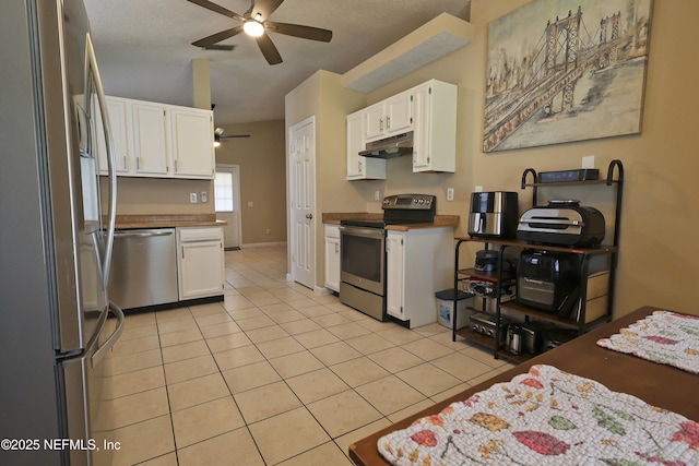 502 Vermont Ave, Green Cove Springs, FL 32043 - kitchen with appliances with stainless steel finishes, ceiling fan, white cabinetry, light tile patterned floors, and under cabinet range hood