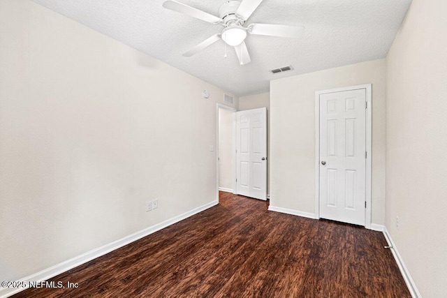 3143 Post St, Jacksonville, FL 32205 - unfurnished bedroom featuring dark wood-type flooring, a textured ceiling, baseboards, and a ceiling fan