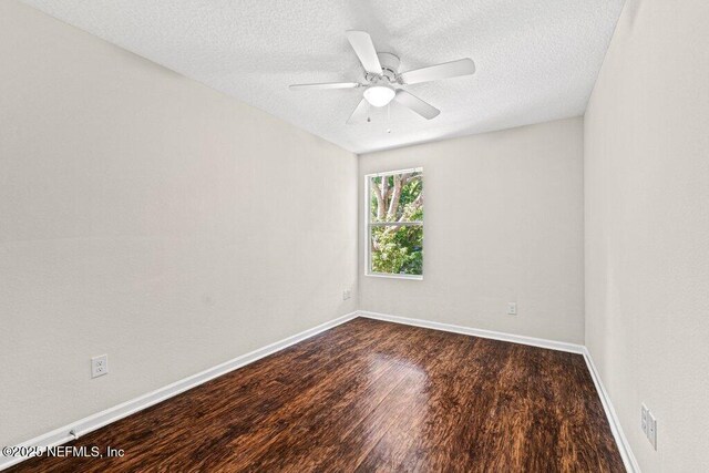 3143 Post St, Jacksonville, FL 32205 - unfurnished room featuring dark wood finished floors, a textured ceiling, ceiling fan, and baseboards