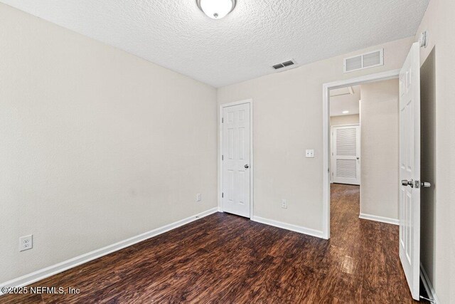 3143 Post St, Jacksonville, FL 32205 - unfurnished bedroom featuring wood finished floors, a textured ceiling, and baseboards