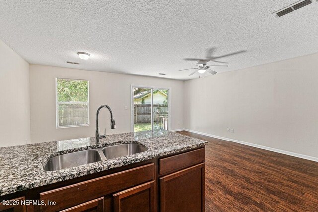 3143 Post St, Jacksonville, FL 32205 - kitchen with a sink, ceiling fan, stone counters, dark wood-style flooring, and dark brown cabinetry