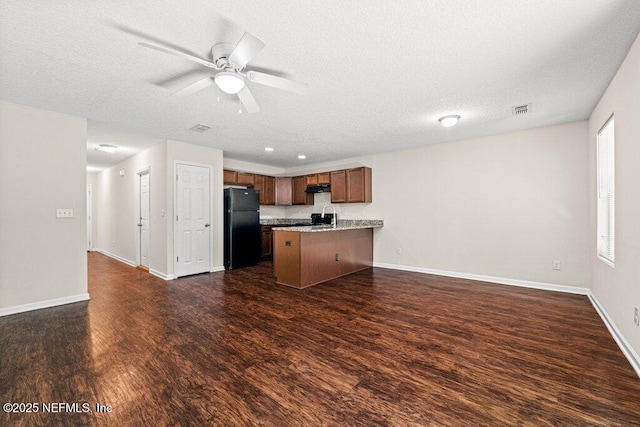 3143 Post St, Jacksonville, FL 32205 - kitchen featuring freestanding refrigerator, a peninsula, open floor plan, under cabinet range hood, and a sink