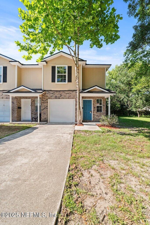 3143 Post St, Jacksonville, FL 32205 - view of front of house with driveway, a garage, and brick siding