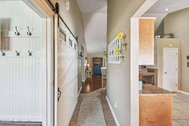 3684 Arava Dr, Green Cove Springs, FL 32043 - hall with a barn door, light tile patterned floors, and baseboards