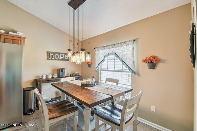 3684 Arava Dr, Green Cove Springs, FL 32043 - dining space featuring vaulted ceiling, light tile patterned flooring, and baseboards