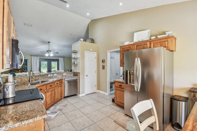 3684 Arava Dr, Green Cove Springs, FL 32043 - kitchen with stainless steel appliances, a sink, a ceiling fan, light tile patterned floors, and brown cabinetry