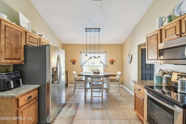 3684 Arava Dr, Green Cove Springs, FL 32043 - kitchen featuring stainless steel appliances, a textured ceiling, light tile patterned floors, pendant lighting, and brown cabinets