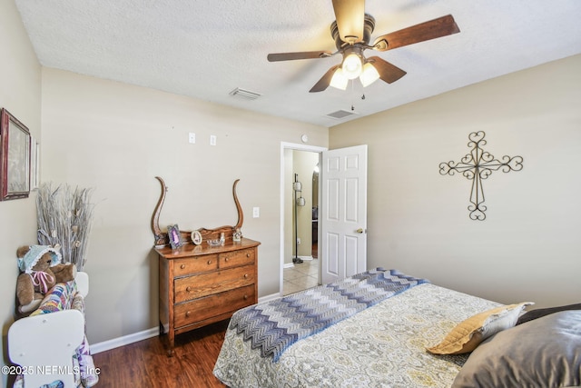 3684 Arava Dr, Green Cove Springs, FL 32043 - bedroom with baseboards, wood finished floors, a ceiling fan, and a textured ceiling