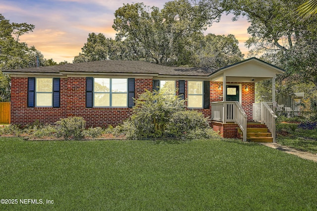 8198 Paul Jones Dr, Jacksonville, FL 32208 - ranch-style home with a front lawn and brick siding
