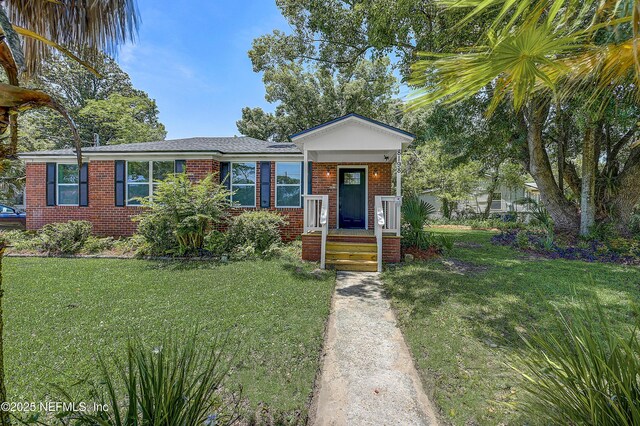 8198 Paul Jones Dr, Jacksonville, FL 32208 - view of front of home with brick siding and a front lawn
