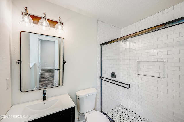 8198 Paul Jones Dr, Jacksonville, FL 32208 - bathroom featuring a shower stall, a textured ceiling, toilet, and vanity