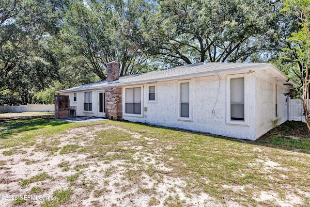 6124 Blank Dr, Jacksonville, FL 32244 - rear view of property featuring a chimney and stucco siding