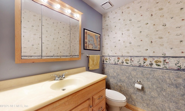 5325 Julington Ridge Dr S, Jacksonville, FL 32258 - bathroom featuring toilet, wallpapered walls, and vanity