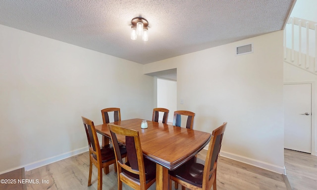 5325 Julington Ridge Dr S, Jacksonville, FL 32258 - dining space with light wood-style flooring, a textured ceiling, and baseboards