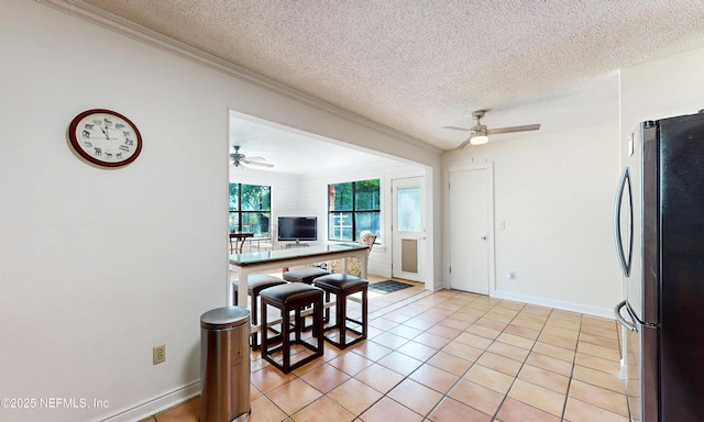 5325 Julington Ridge Dr S, Jacksonville, FL 32258 - kitchen featuring freestanding refrigerator, a ceiling fan, a textured ceiling, ornamental molding, and light tile patterned floors