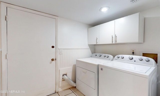 5325 Julington Ridge Dr S, Jacksonville, FL 32258 - laundry area with cabinet space, washer and clothes dryer, a wainscoted wall, and light tile patterned floors